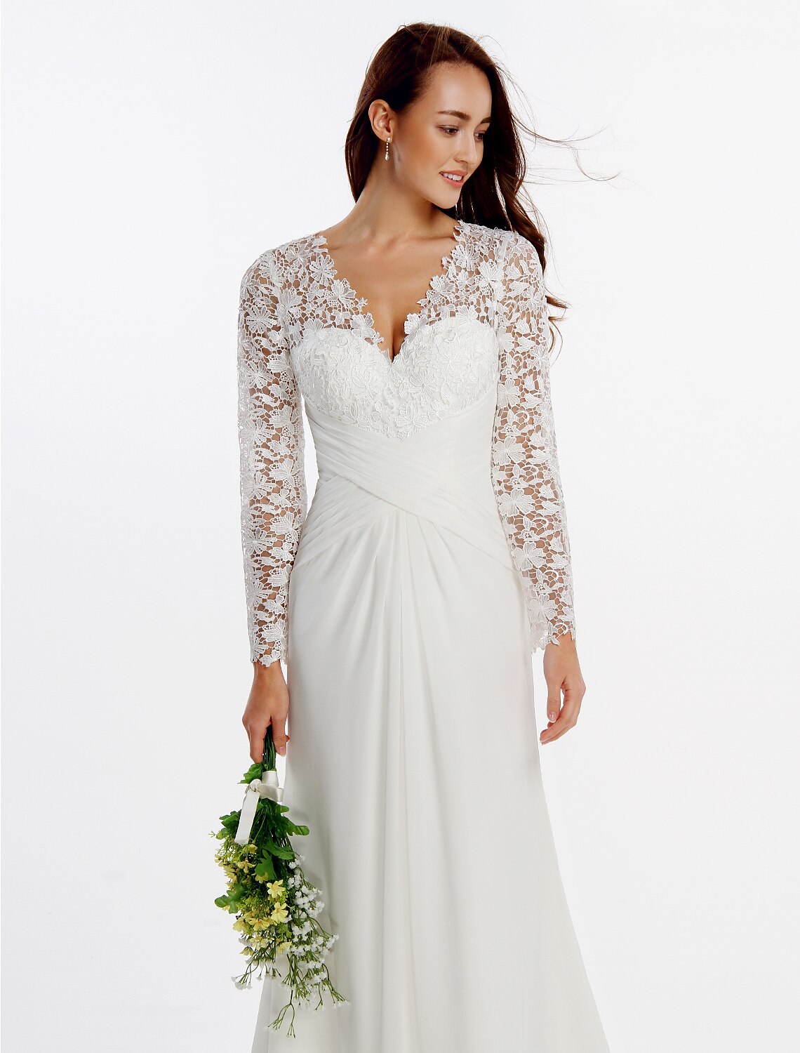 Full length view of a white Boho wedding dress with long sleeves and a flowing skirt.