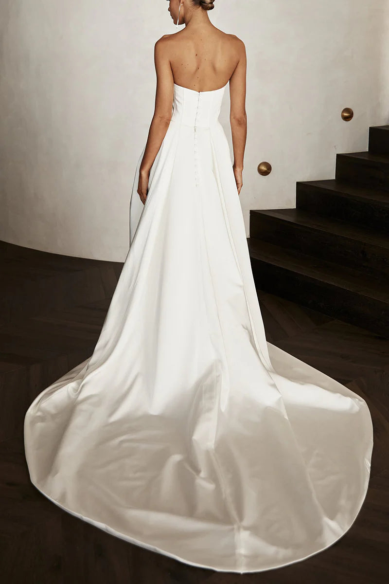 Side view of a woman in a Boho strapless satin wedding dress, showcasing the ankle-length design.