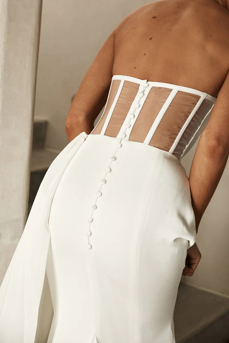 Close-up of the V-neckline and bead embellishments on the Boho strapless satin wedding dress.