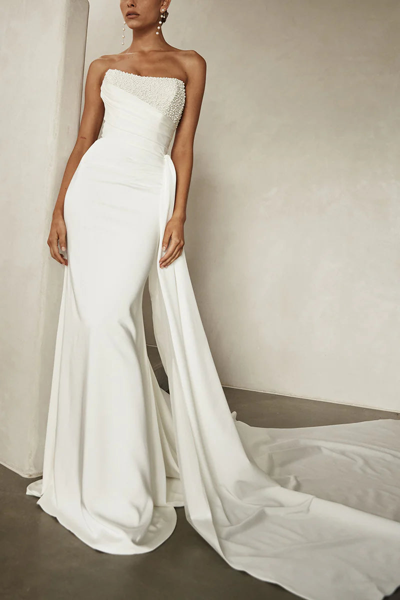 Back view of a woman in the Boho strapless satin wedding dress, highlighting the flowing fabric.