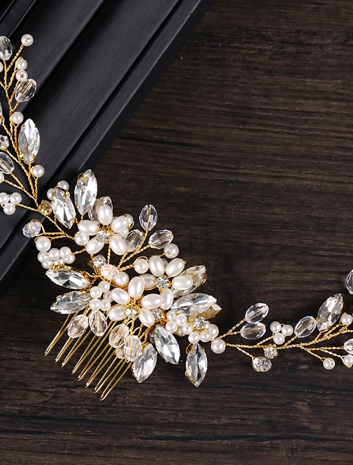 Side view of a bridal hair comb, highlighting its curved design and sparkling embellishments.