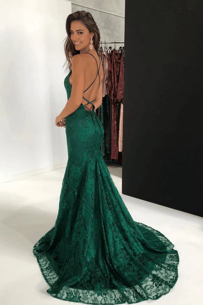Full-length view of a model in a burgundy mermaid prom dress with lace details.