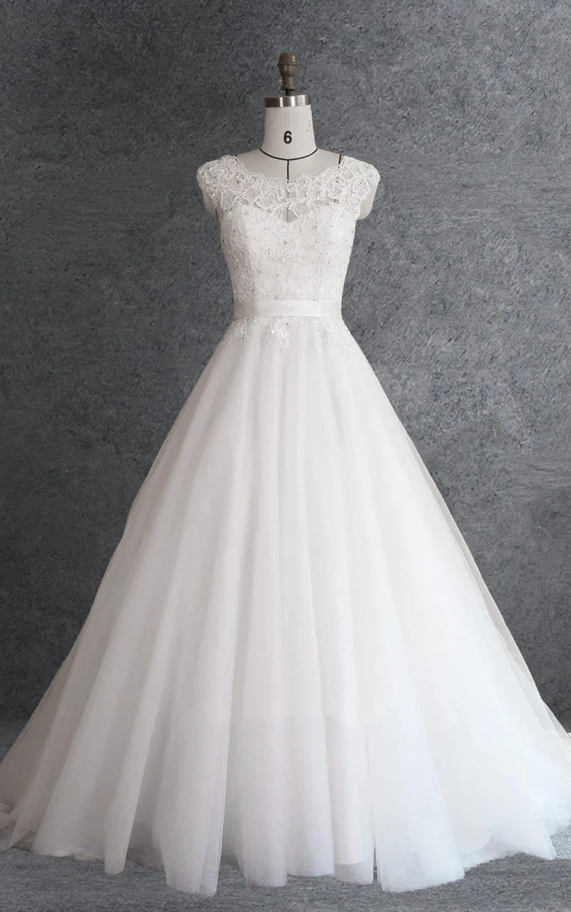 Elegant silver ball gown with cap sleeves, lace appliques, and intricate beading.