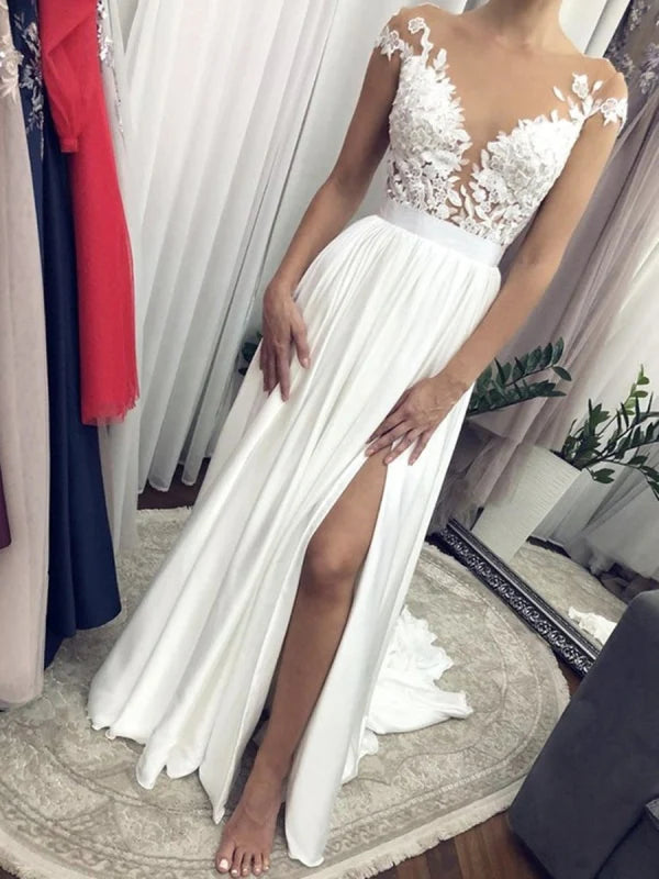 Elegant lace wedding gown with cap sleeves and a round neck.