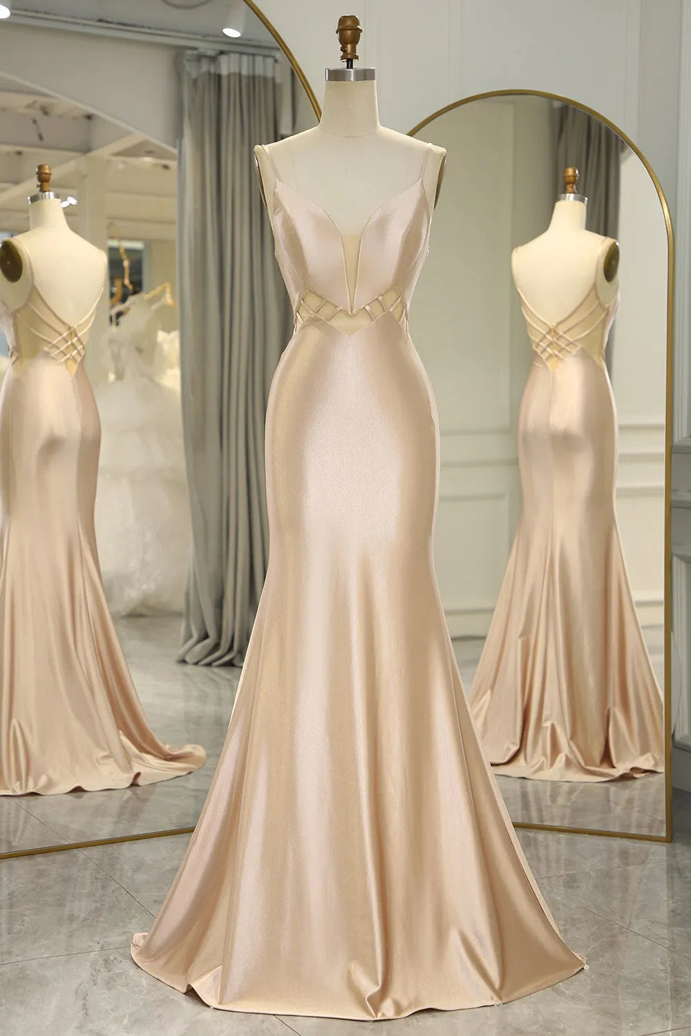 Champagne mermaid satin prom dress with spaghetti straps, front view.