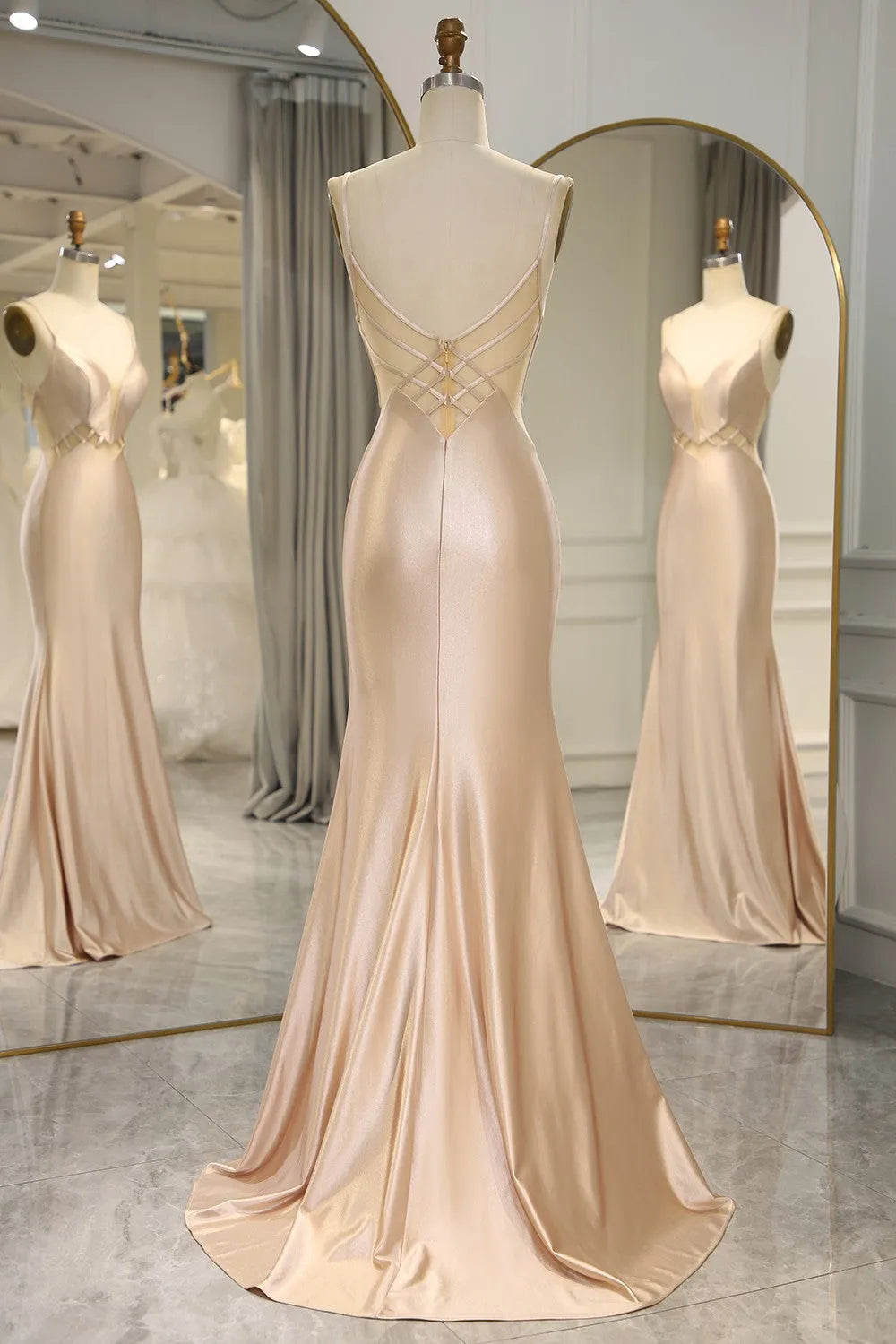 Side view of a woman wearing a Champagne mermaid satin prom dress.