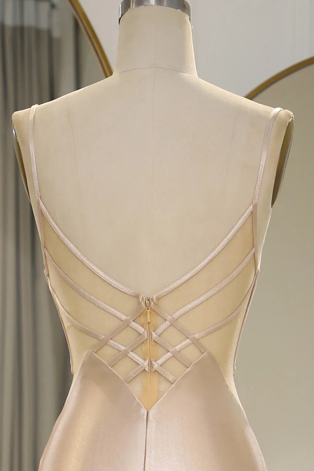 Back view of a Champagne mermaid satin prom dress, showing the elegant train.