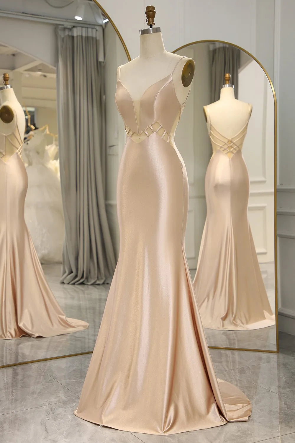 Woman posing in a Champagne mermaid satin long prom dress.