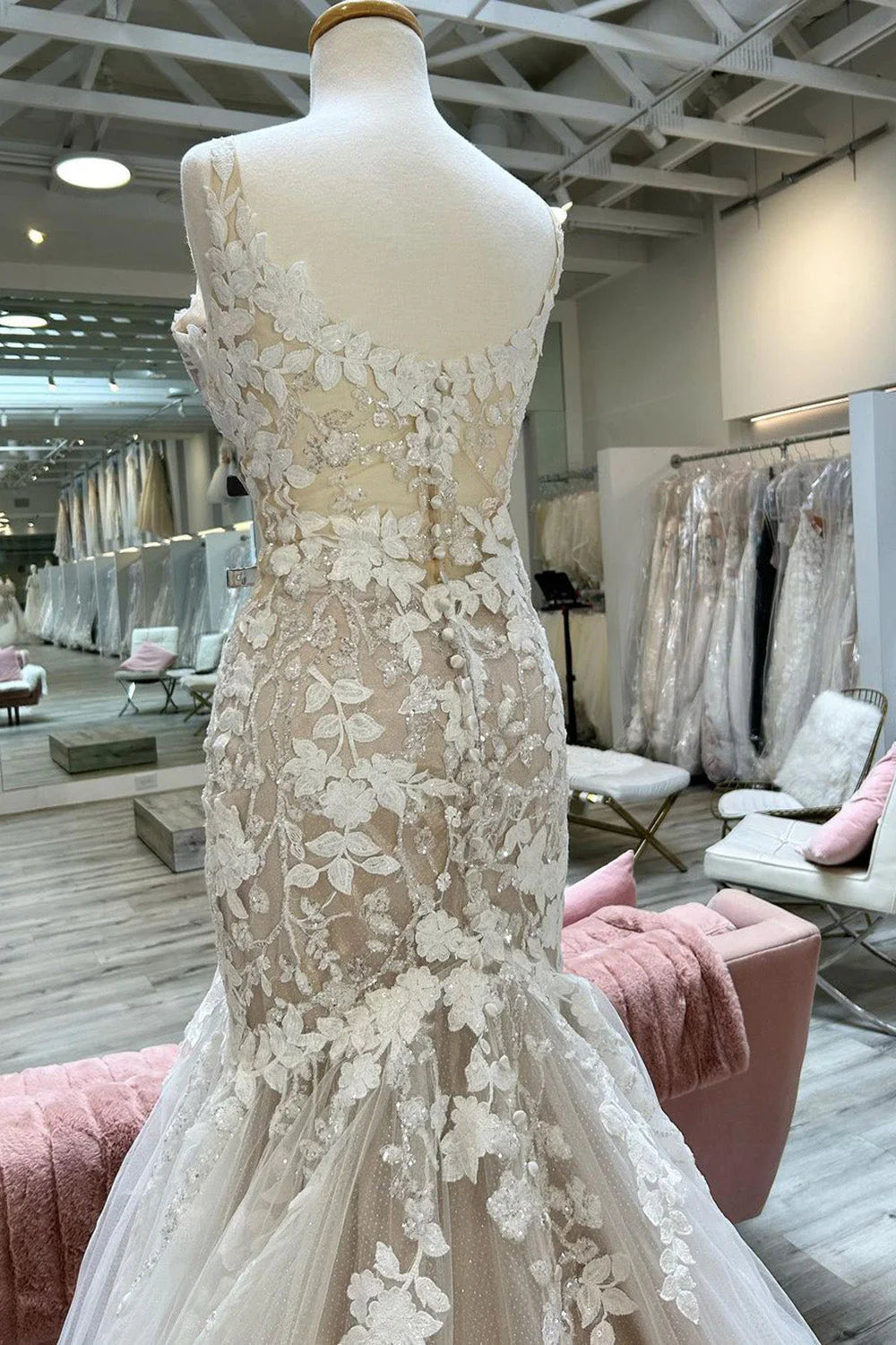 Side profile of bride in champagne mermaid V-neck gown.