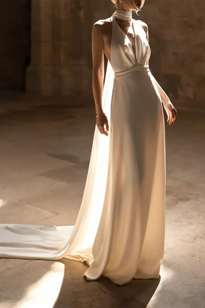 A-Line boho wedding dress with a backless design and sweep train.