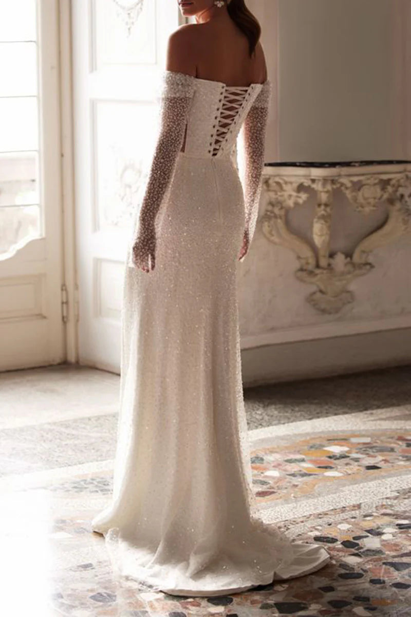 Bride wearing a sleeveless A-Line wedding gown with a flowing train.
