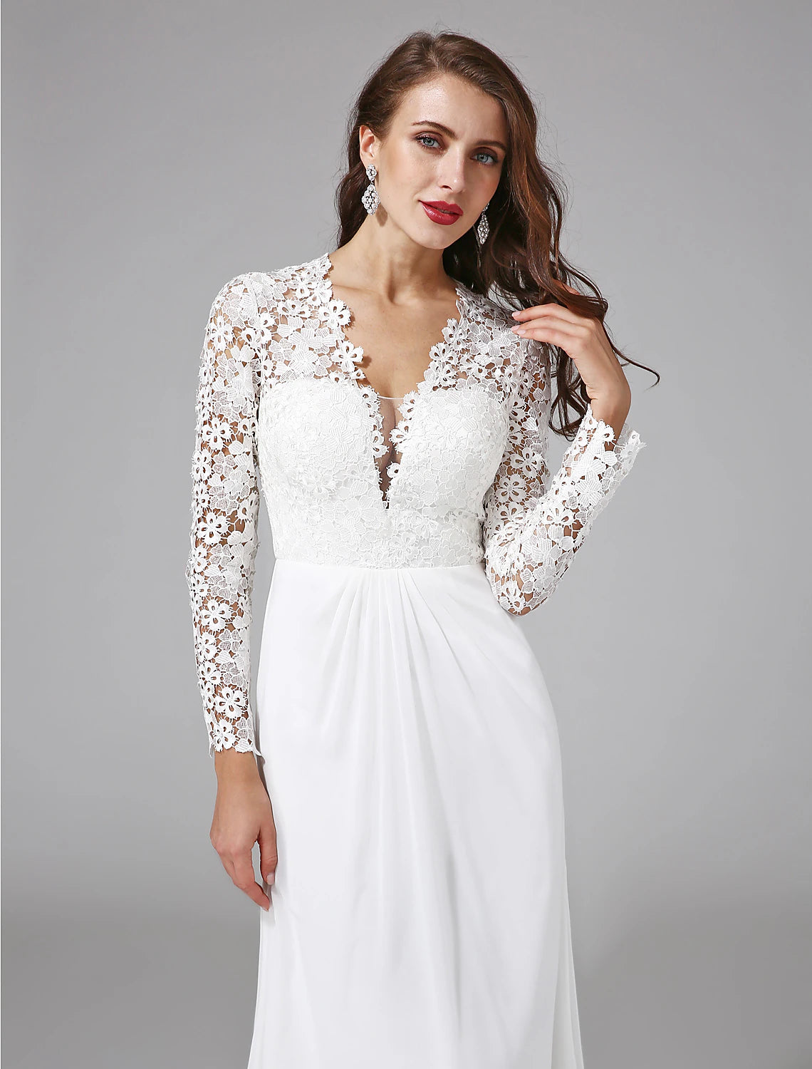 Side profile of a bride wearing a long sleeve illusion neck wedding gown.