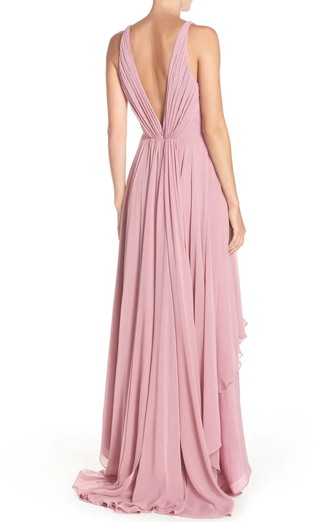 Woman wearing a sleeveless high-low prom dress.
