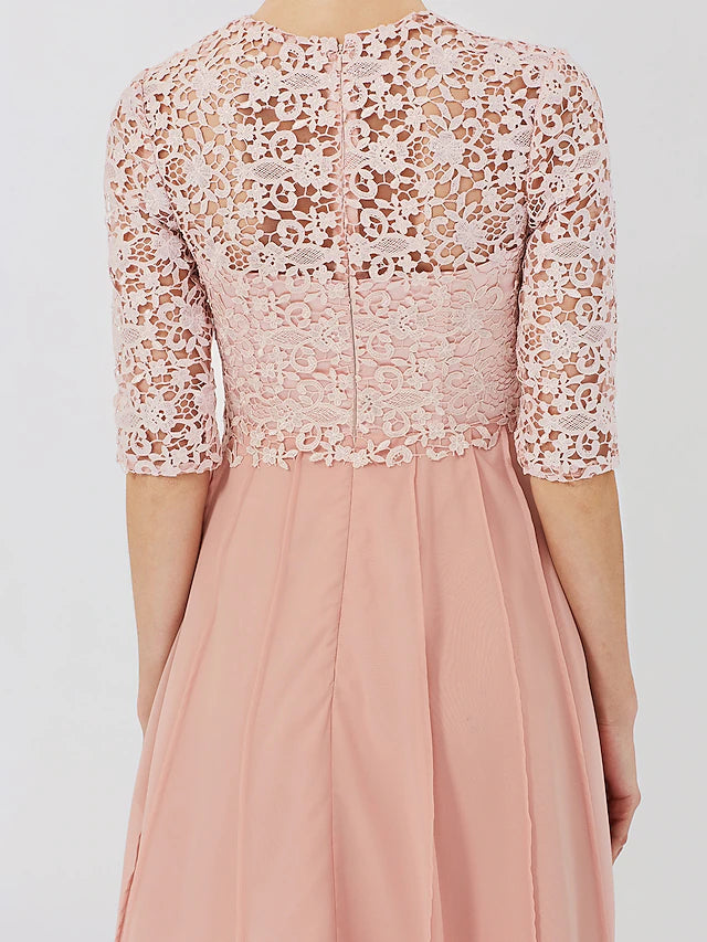 Close-up of the floral lace and crystal brooch on the dress.