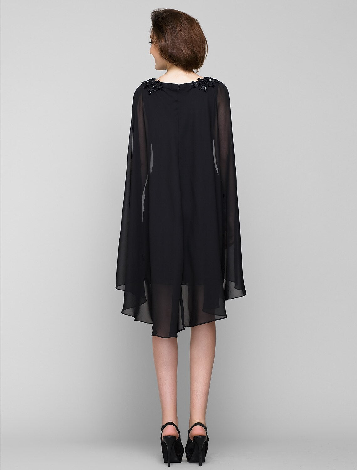 Back view of the sleeveless bateau neck sheath dress.