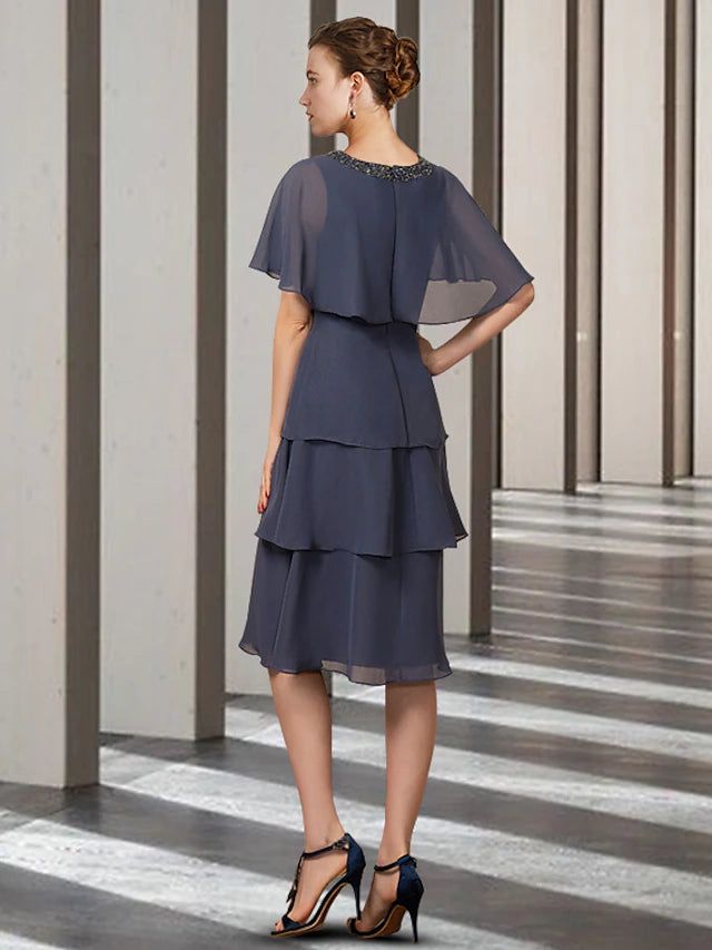 Side view of the knee-length chiffon Mother of the Bride dress.