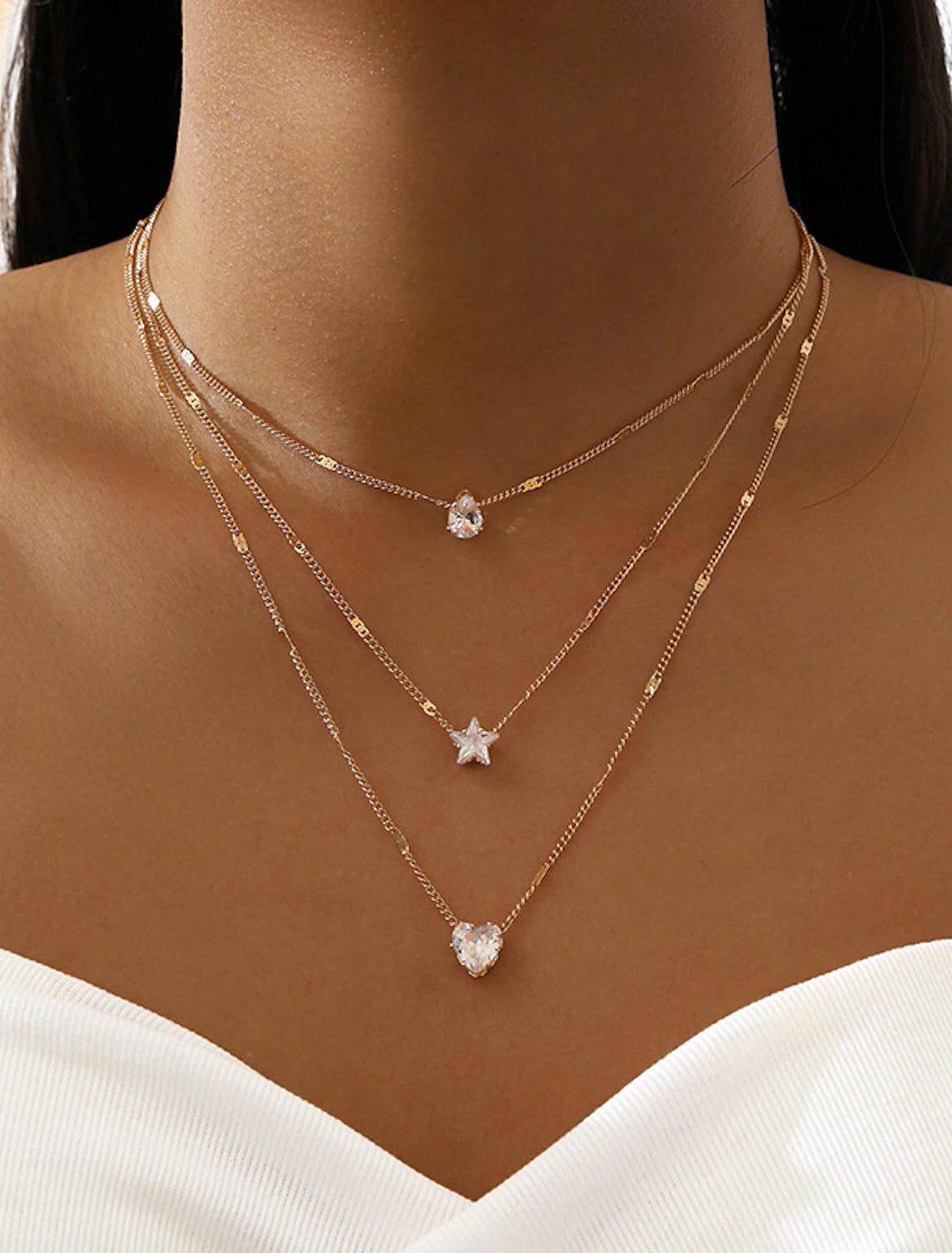 Elegant chrome geometric necklace displayed on a model.
