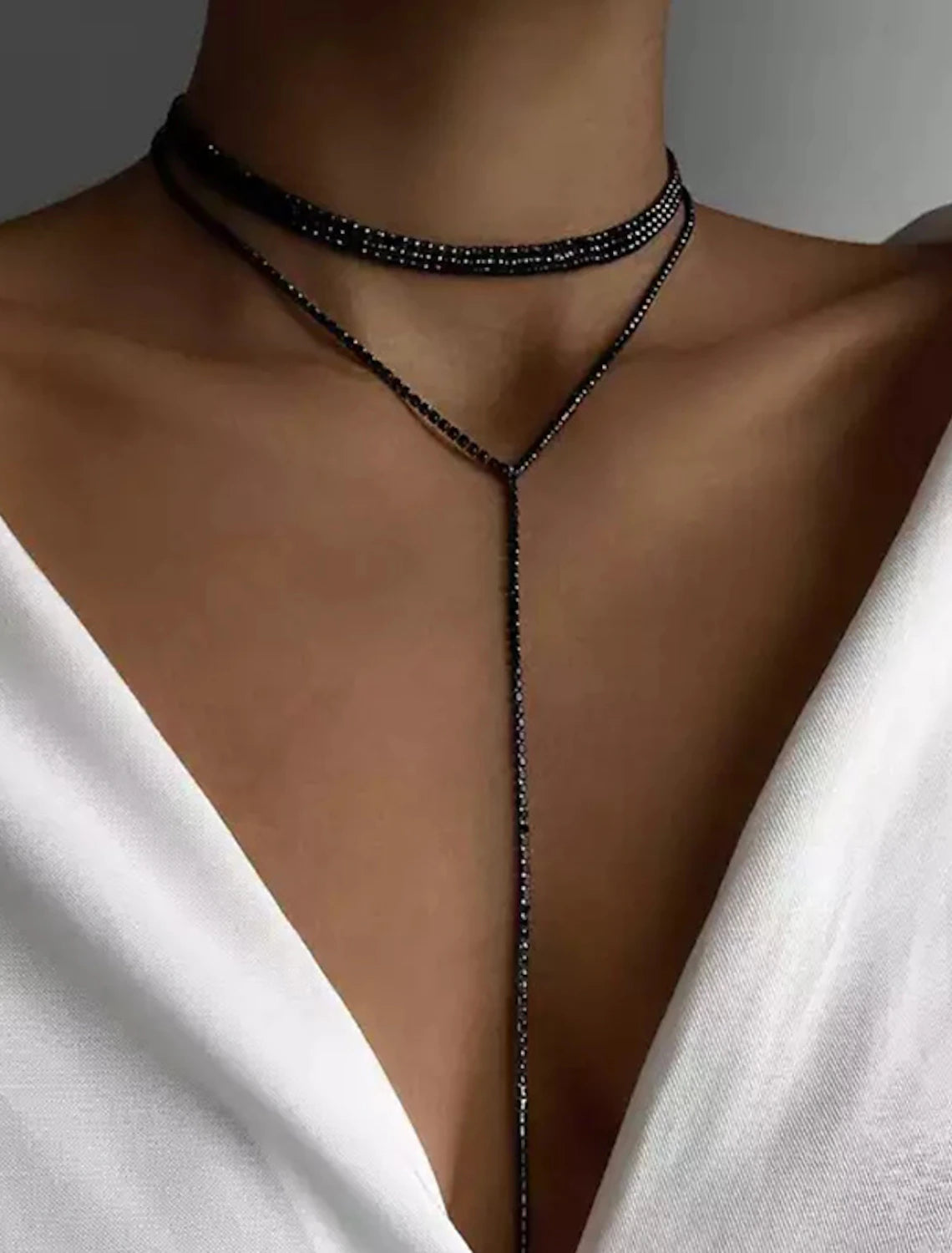 Close-up view of the intricate clear rhinestone geometric necklace.