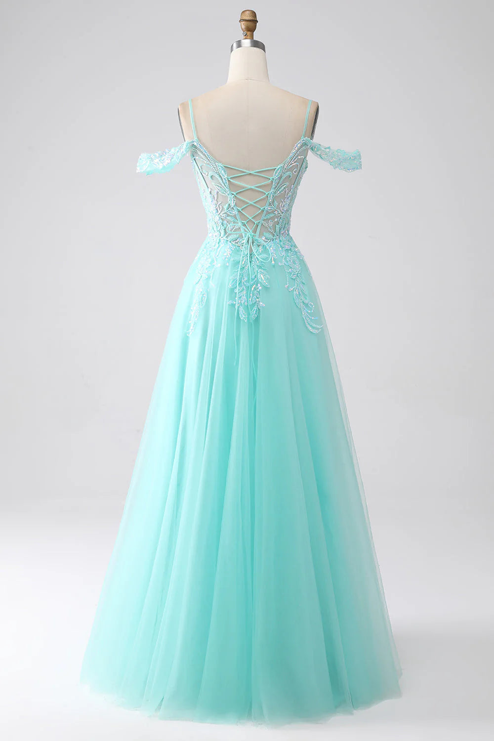 Side view of light green sequin prom dress with cold shoulder detail.
