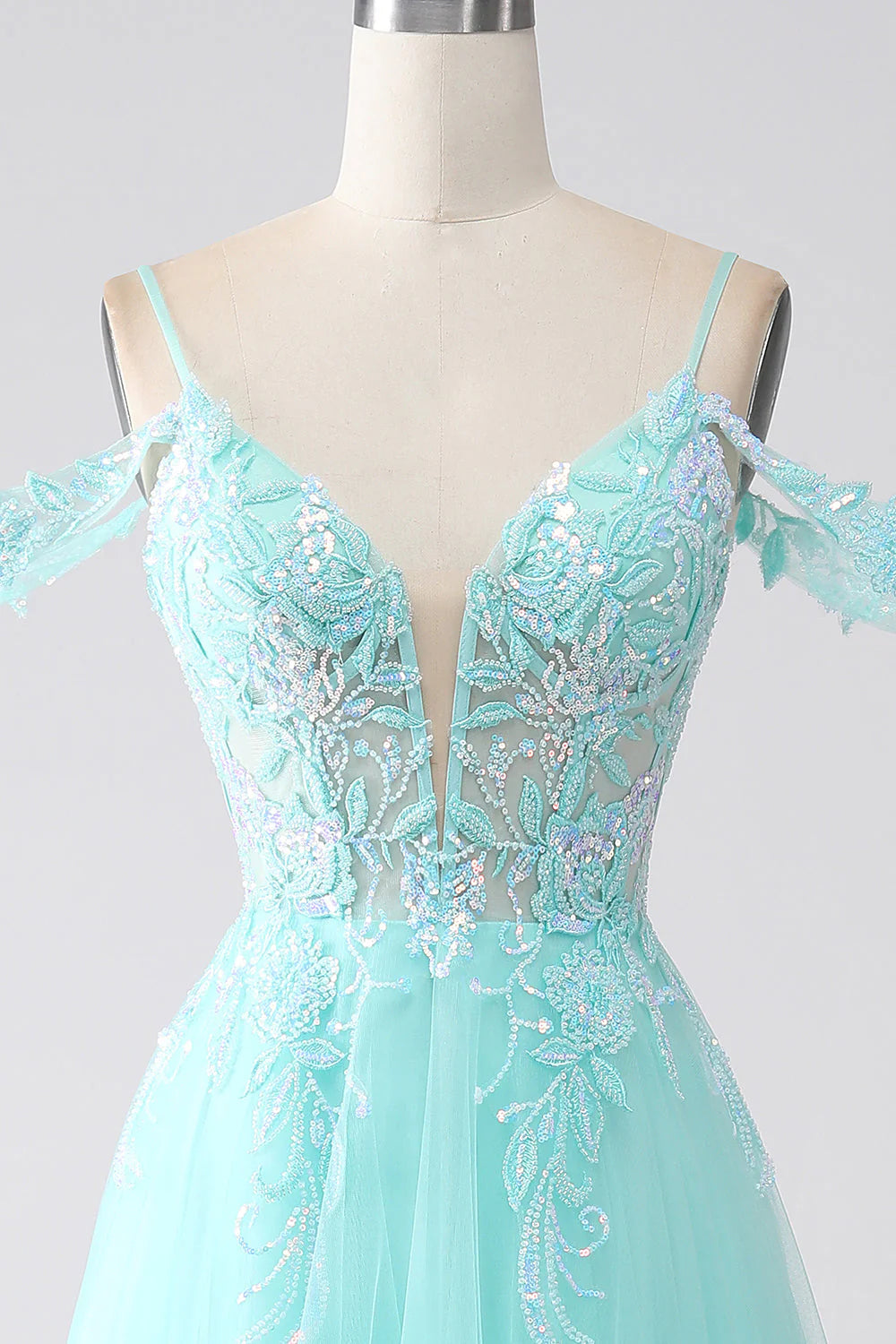 Close-up of sequin embellishments on a light green prom dress.