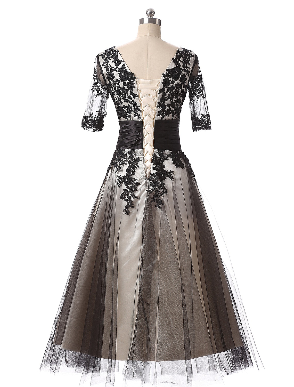 Side profile of the ankle-length lace ball gown.