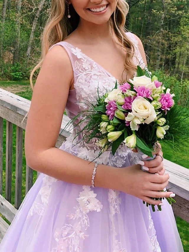 Back view of a formal floor-length tulle prom dress with V-back design.