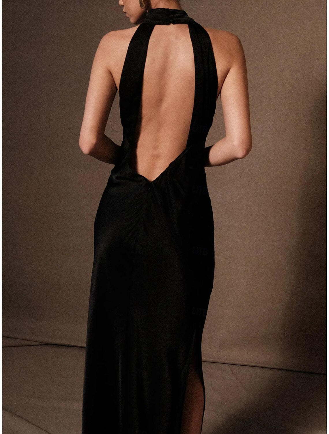 Backless column dress with tie detail, side view.