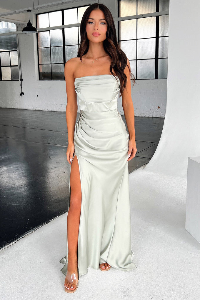 Close-up of the tailored ruching and high slit on a silver sage satin maxi dress.