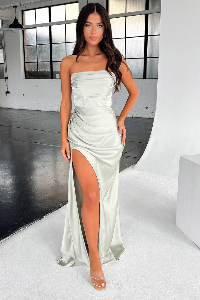 Side view of a model in a silver sage satin strapless gown, highlighting the silhouette.
