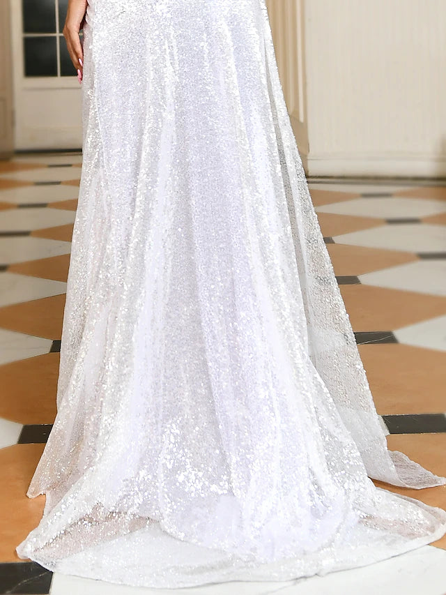 Woman posing in a sequined off-shoulder short sleeve formal dress.