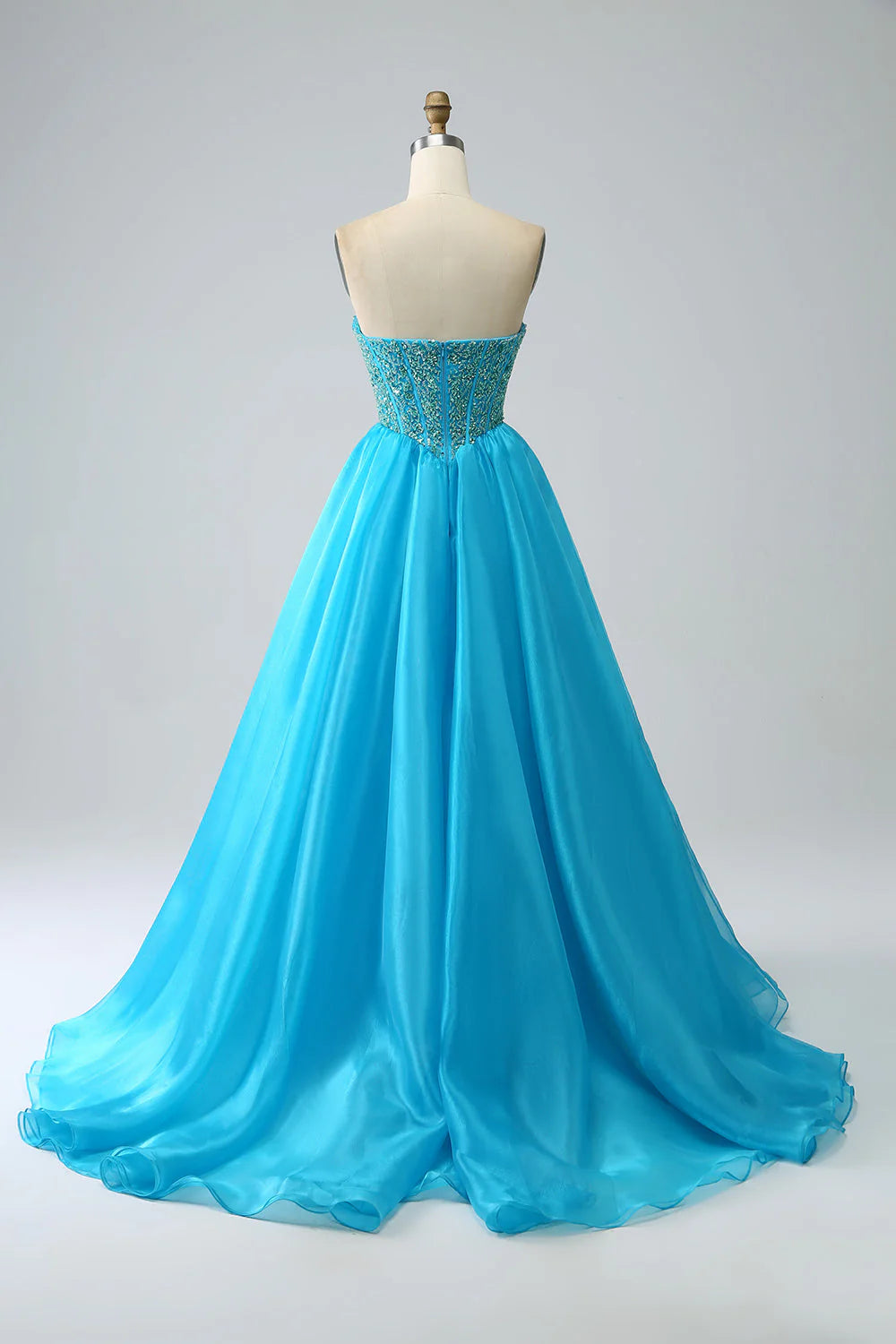Close-up of the corset bodice and detachable sleeves on a blue prom dress.