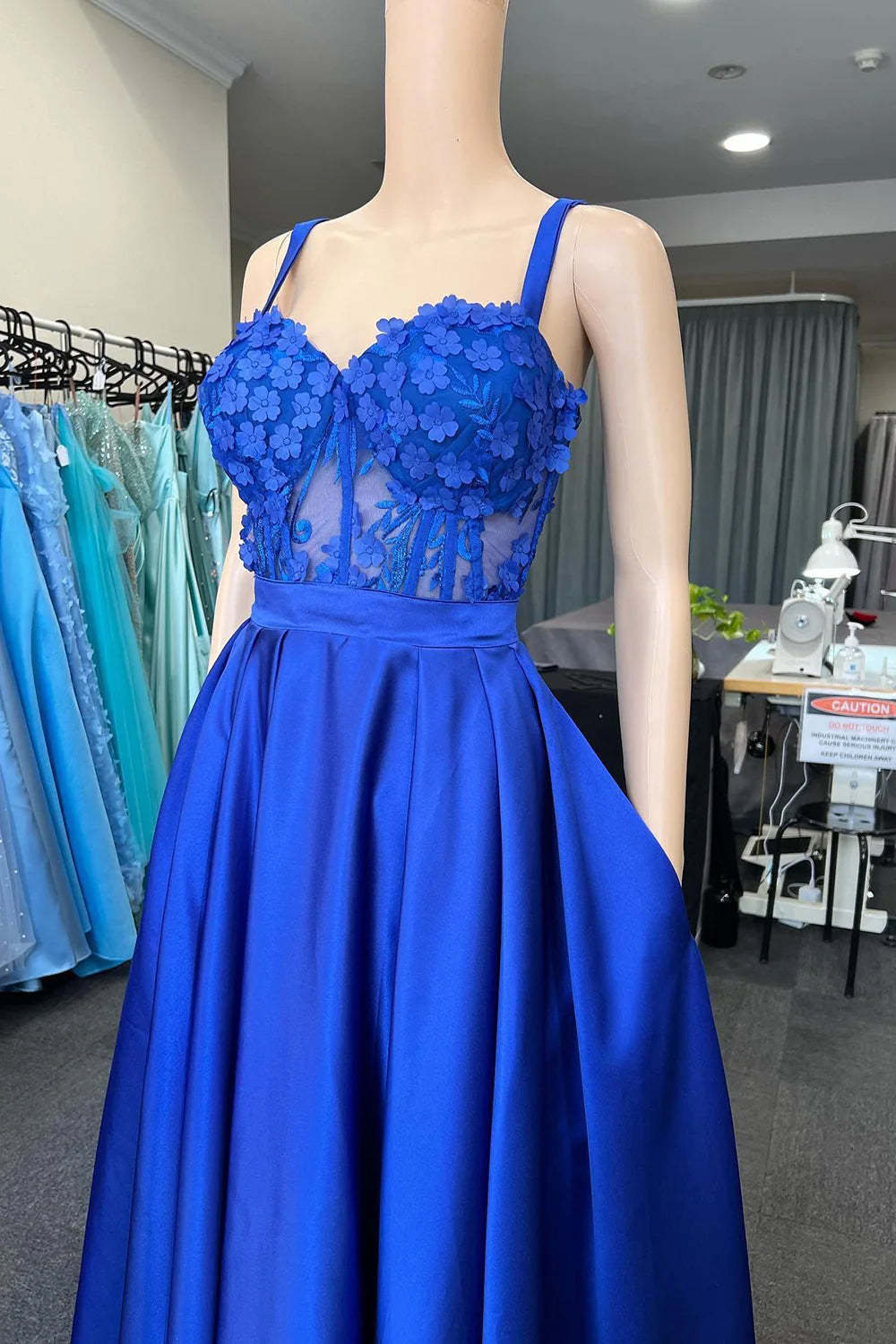 Back view of royal blue formal gown with delicate appliques.