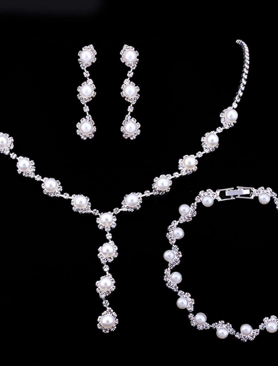Stylish crystal pearl jewelry set displayed on a model.