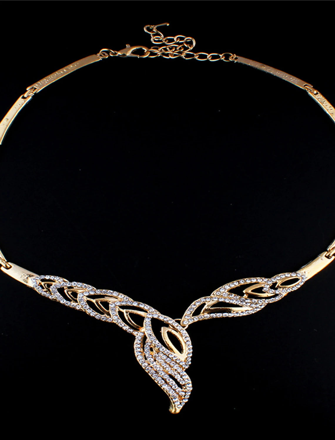 Close-up of sparkling crystal rhinestone bridal necklace and matching drop earrings.