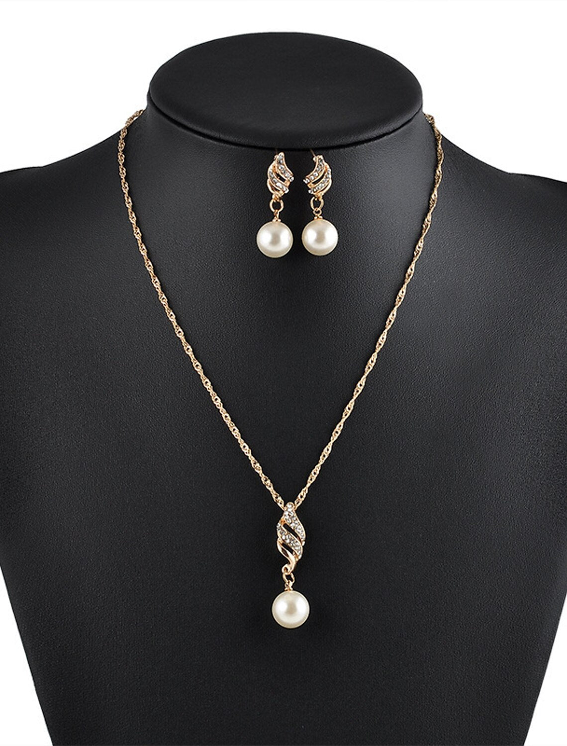 Close-up of the crystal and imitation pearl infinity necklace.