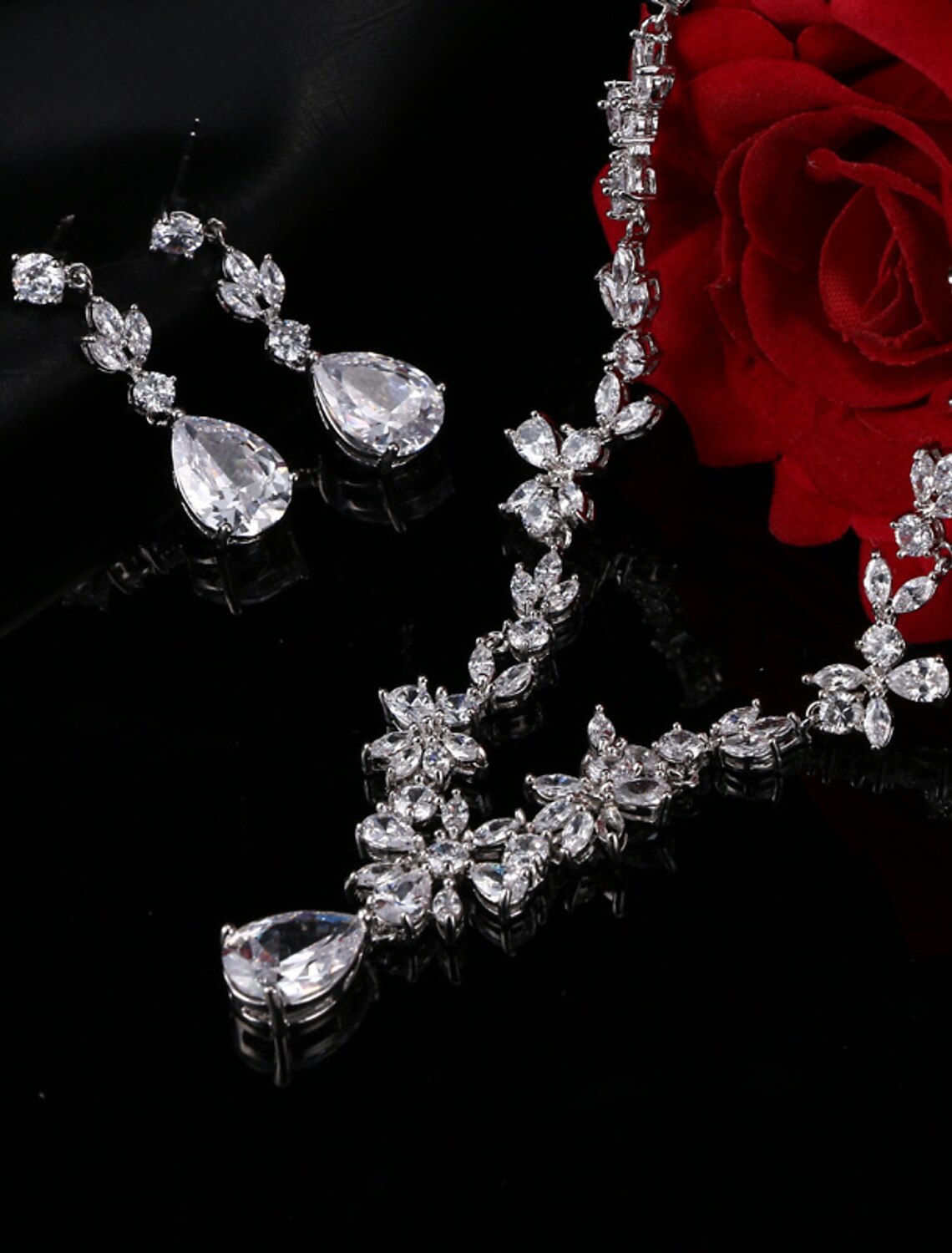 Model showcasing elegant silver-toned cubic zirconia necklace and earrings.