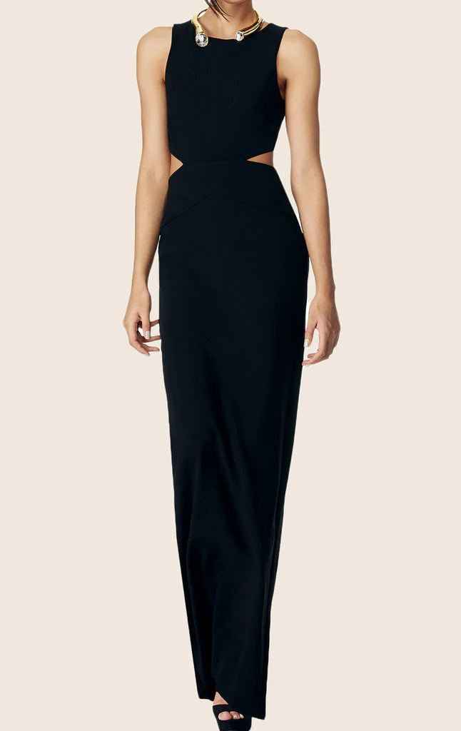Woman posing in an elegant black sleeveless formal maxi gown with a side cut-out.