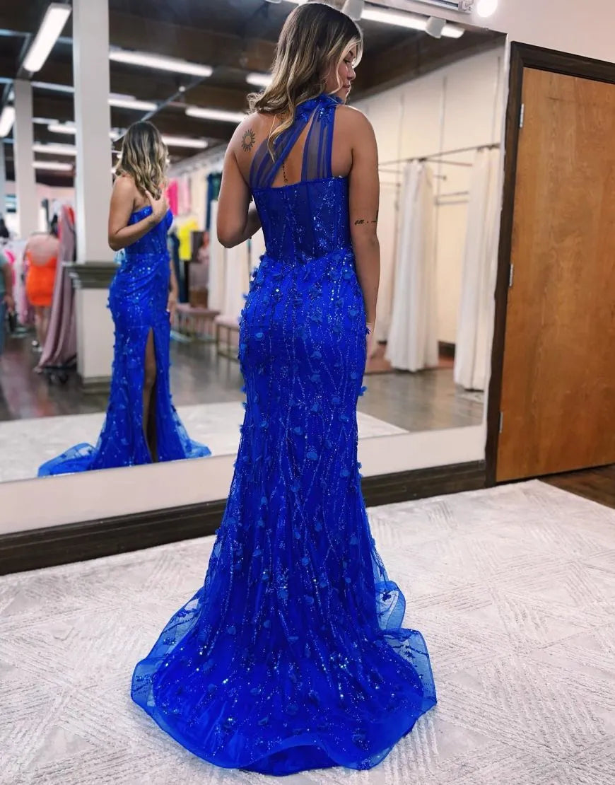 Model showcasing the back of a dark blue one shoulder mermaid gown.