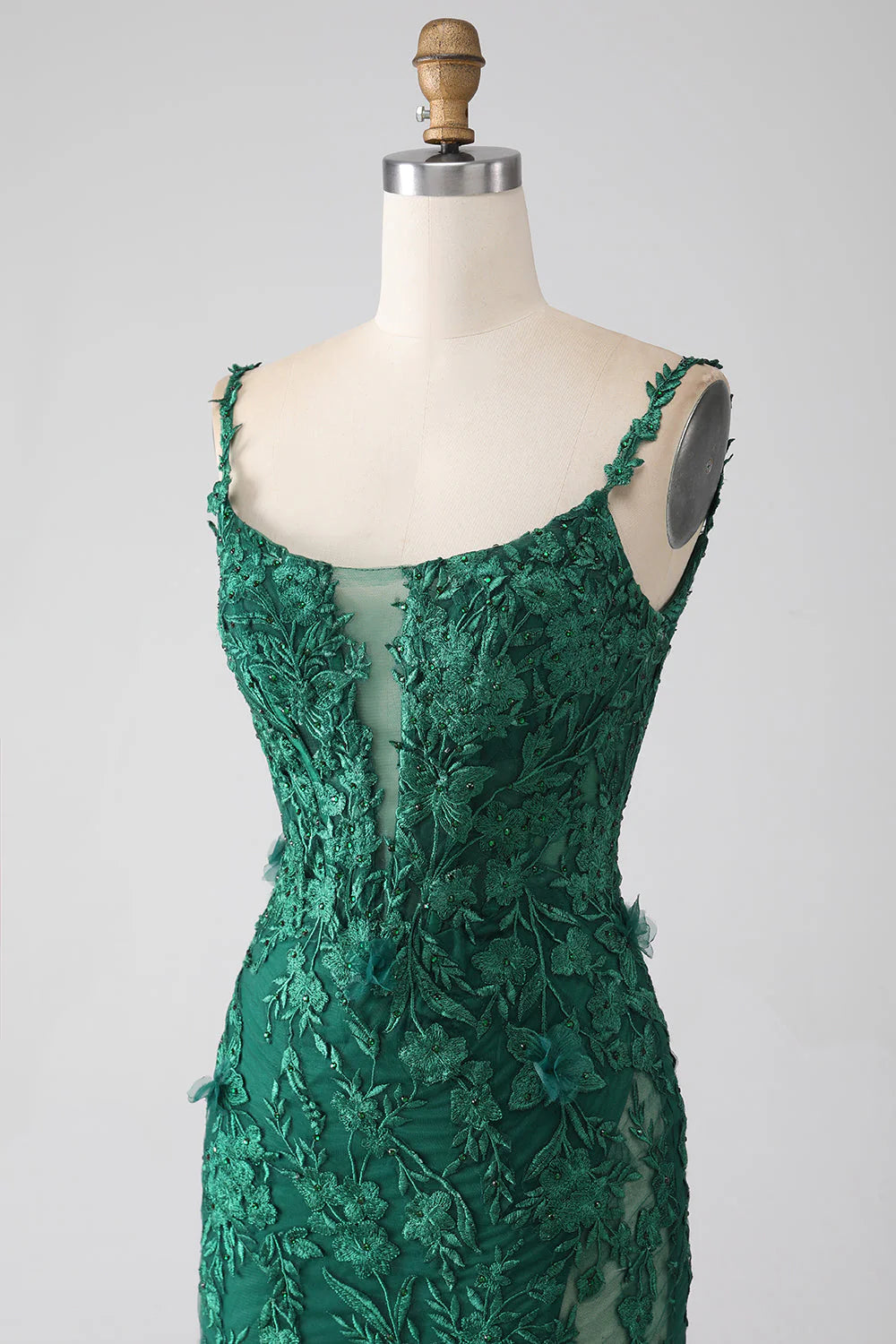 Back view of a dark green V-neck mermaid prom gown with intricate lace.