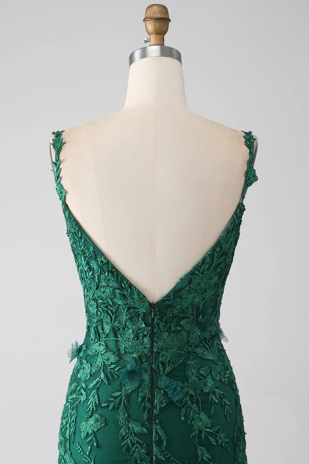 Close-up of the delicate lace detail on a dark green mermaid formal dress.