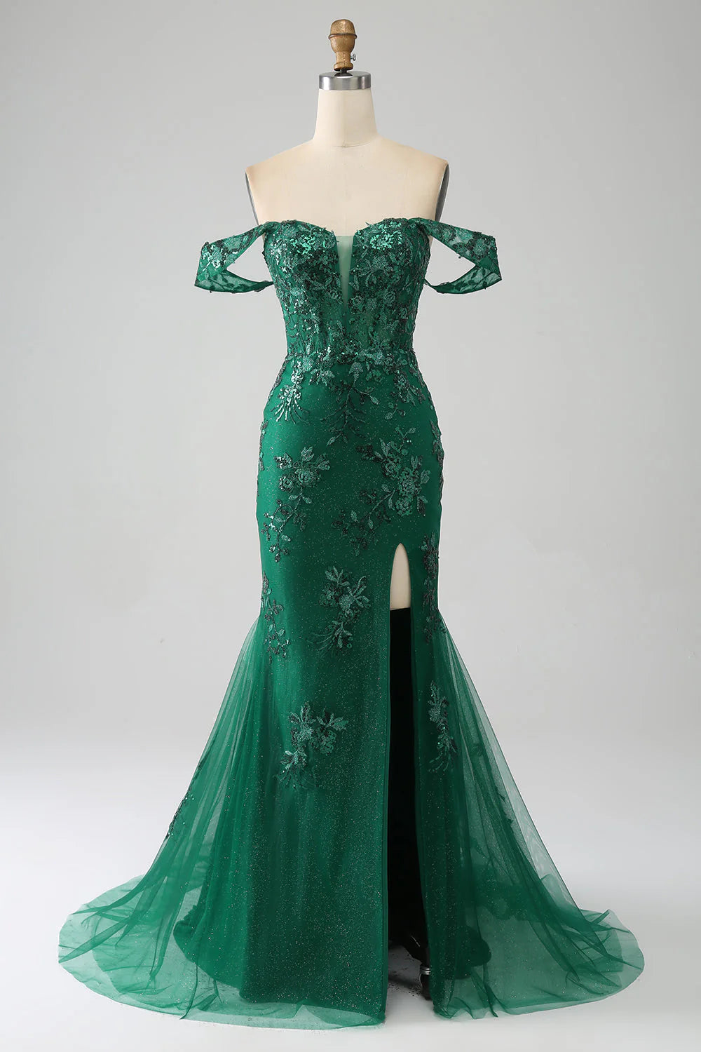 Front view of a dark green mermaid off-shoulder prom dress with intricate appliques.