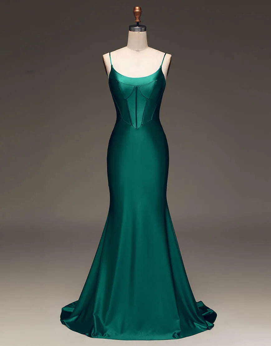 Model wearing a dark green satin prom dress with spaghetti straps and a lace-up back, front view.