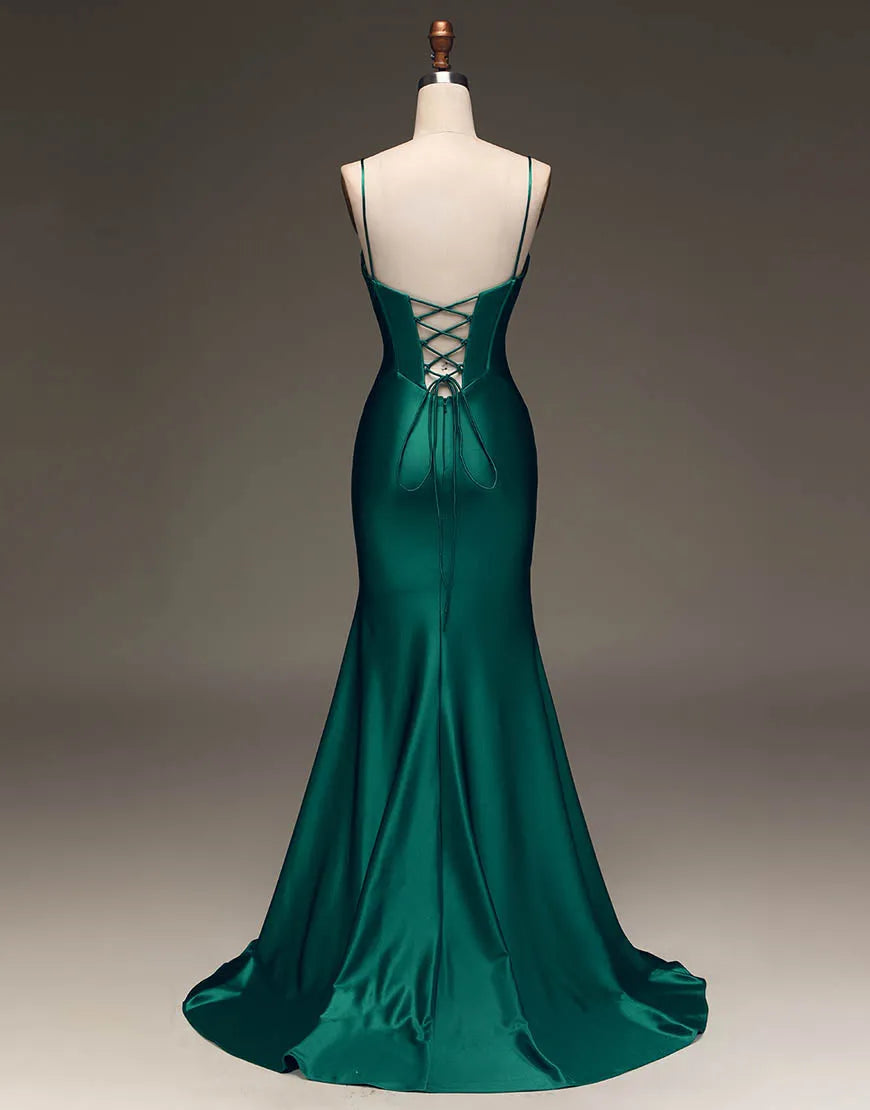 Side view of a model in a dark green satin prom dress, highlighting the fitted silhouette.