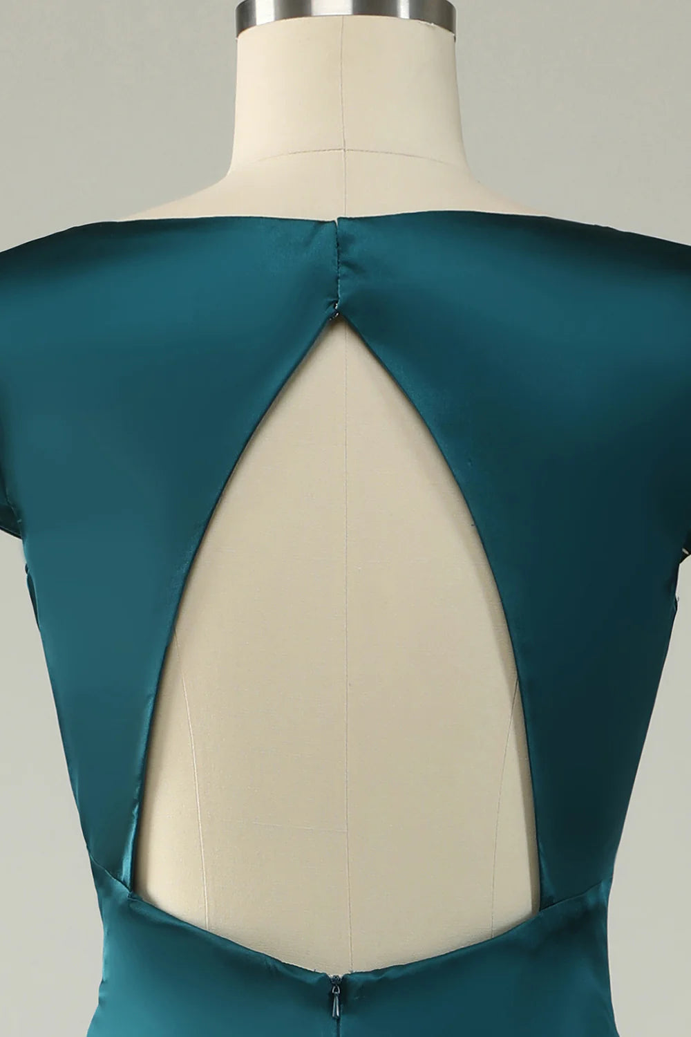Close-up of the dark green satin fabric and V-neck detail on the prom dress.