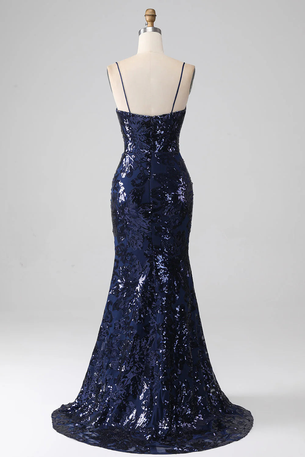 Side view of a dark navy mermaid gown, highlighting the high leg slit.