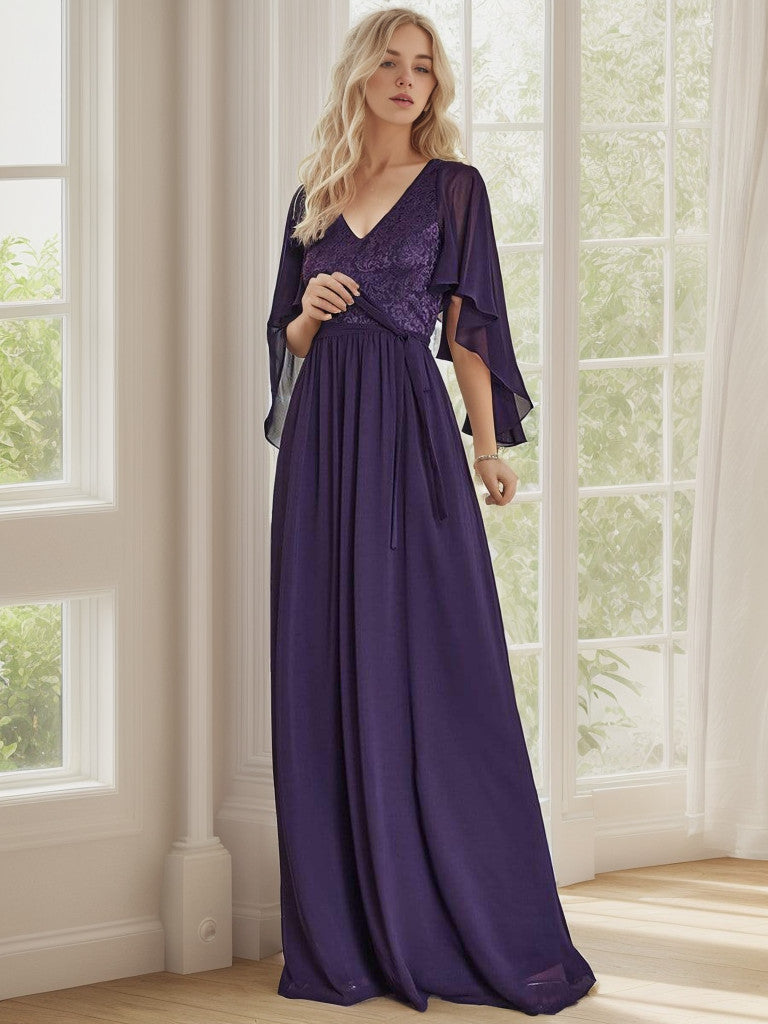 Model showcasing a dark purple deep V-neck lace bodice long flowy evening dress.