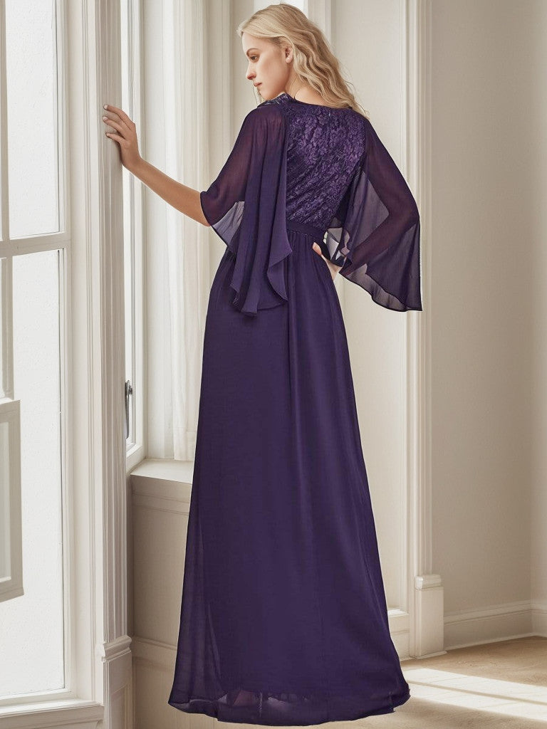 Close-up of the lace bodice and deep V-neck on the dark purple evening dress.