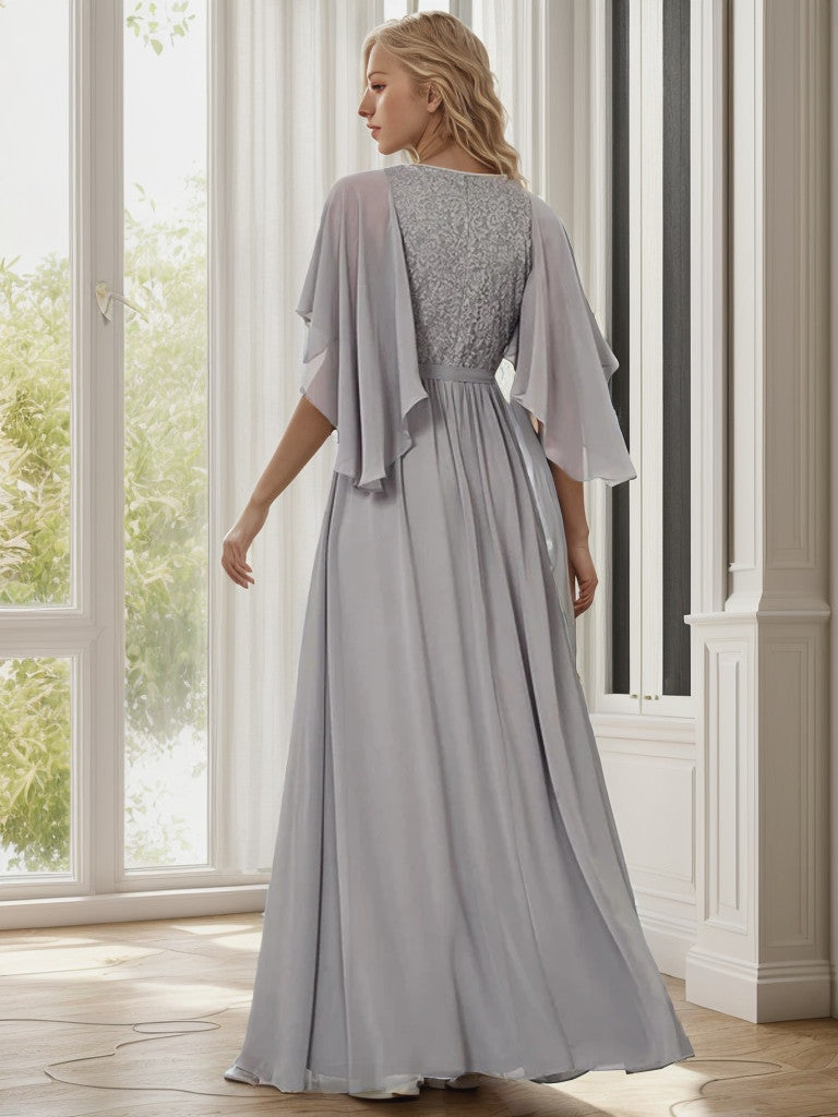 Full length view of the grey deep V-neck lace bodice long flowy evening dress.