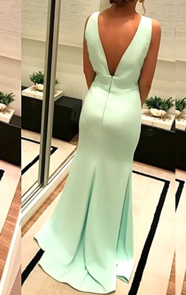 Woman wearing a sleeveless deep V-neck long prom dress.