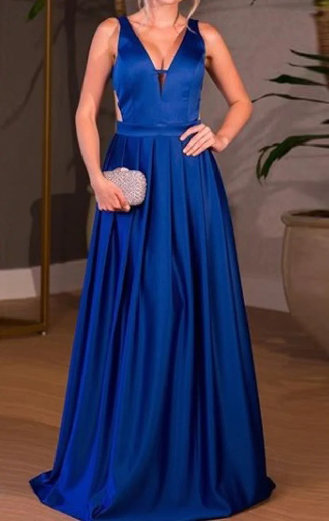Woman posing in an elegant deep V-neck satin long prom dress.